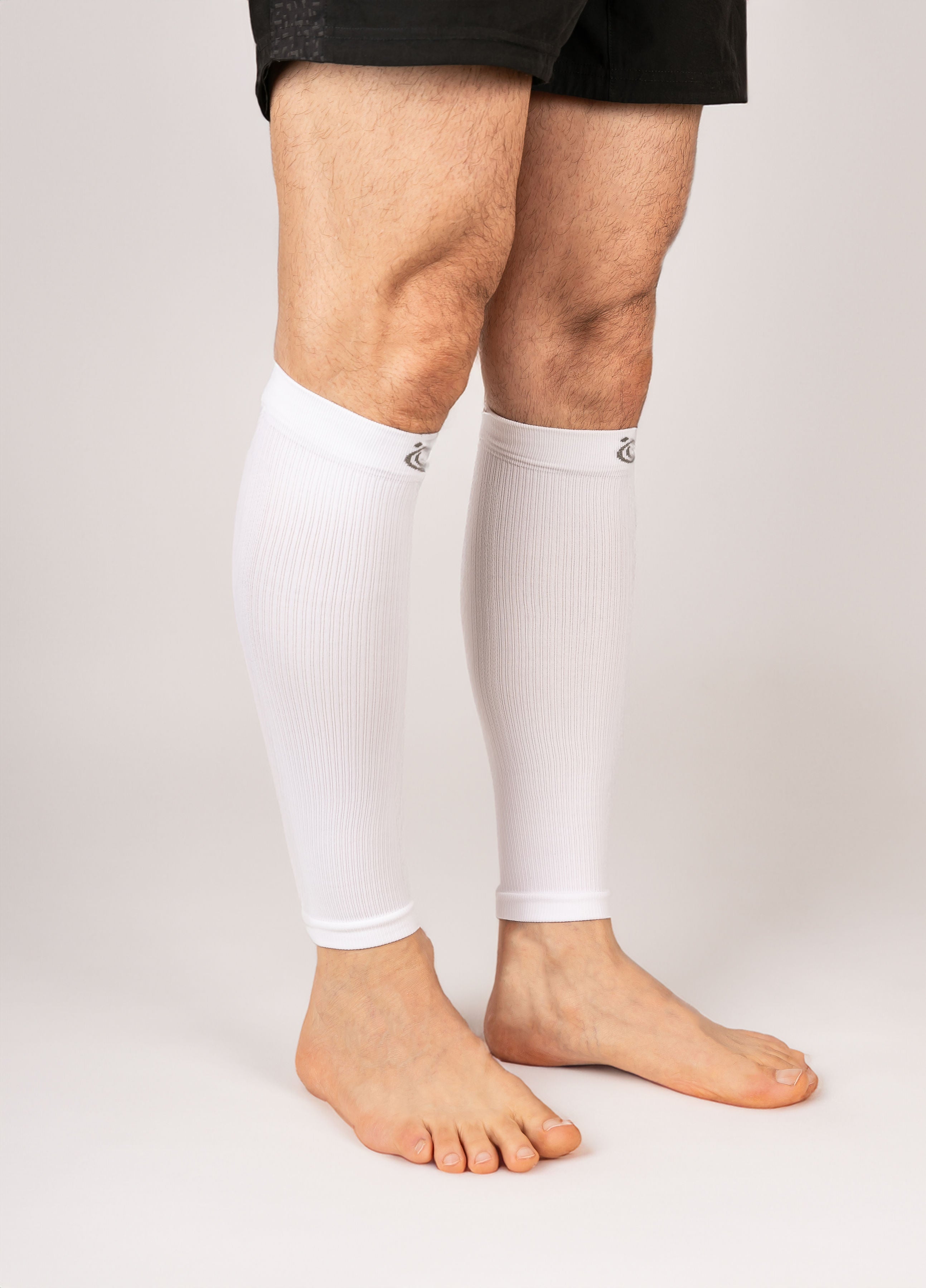 FITLEGs calf compression sleeves in white - worn on model on both calfs.