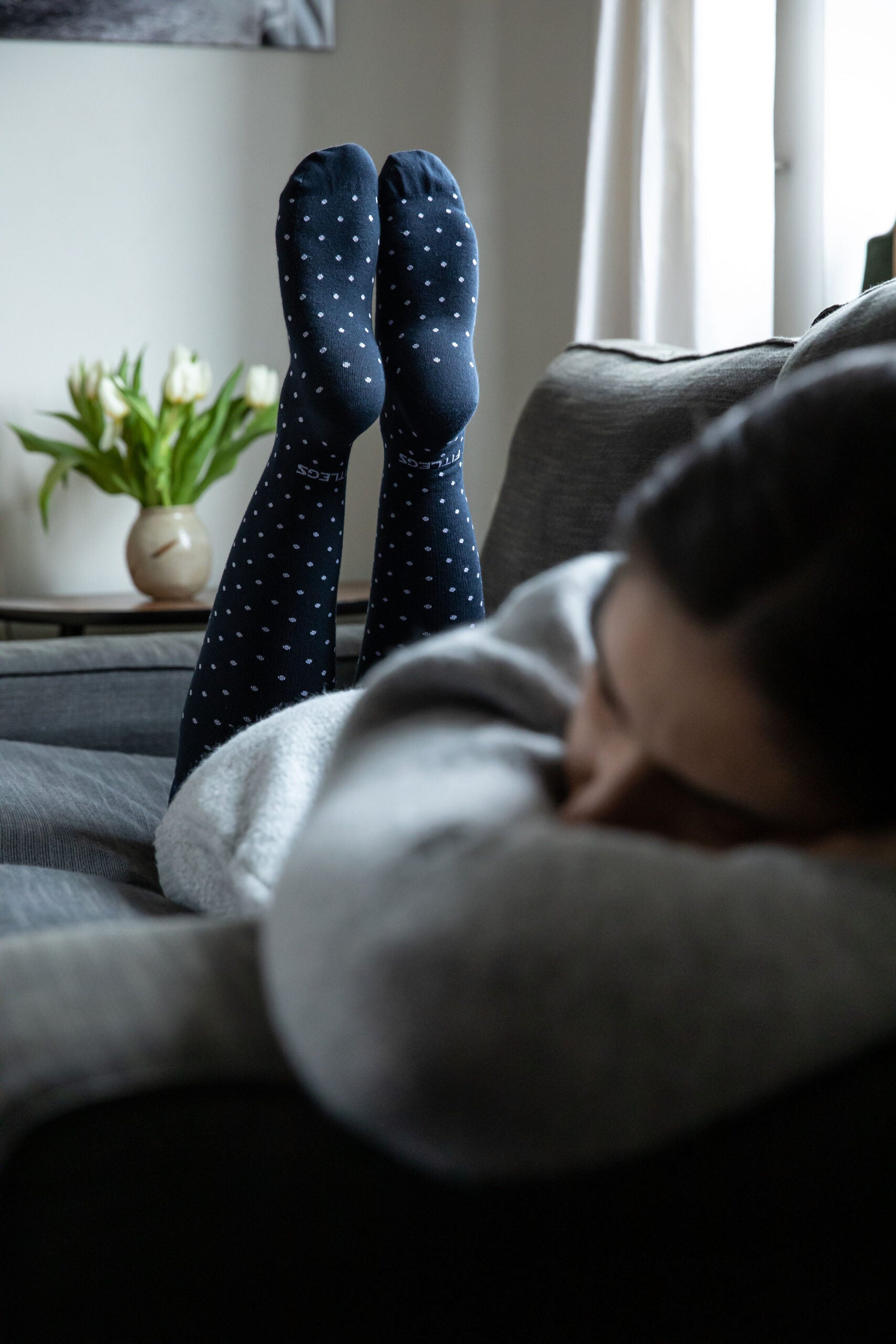 fitlegs everyday life compression socks - polka dot - lifestyle shot on sofa